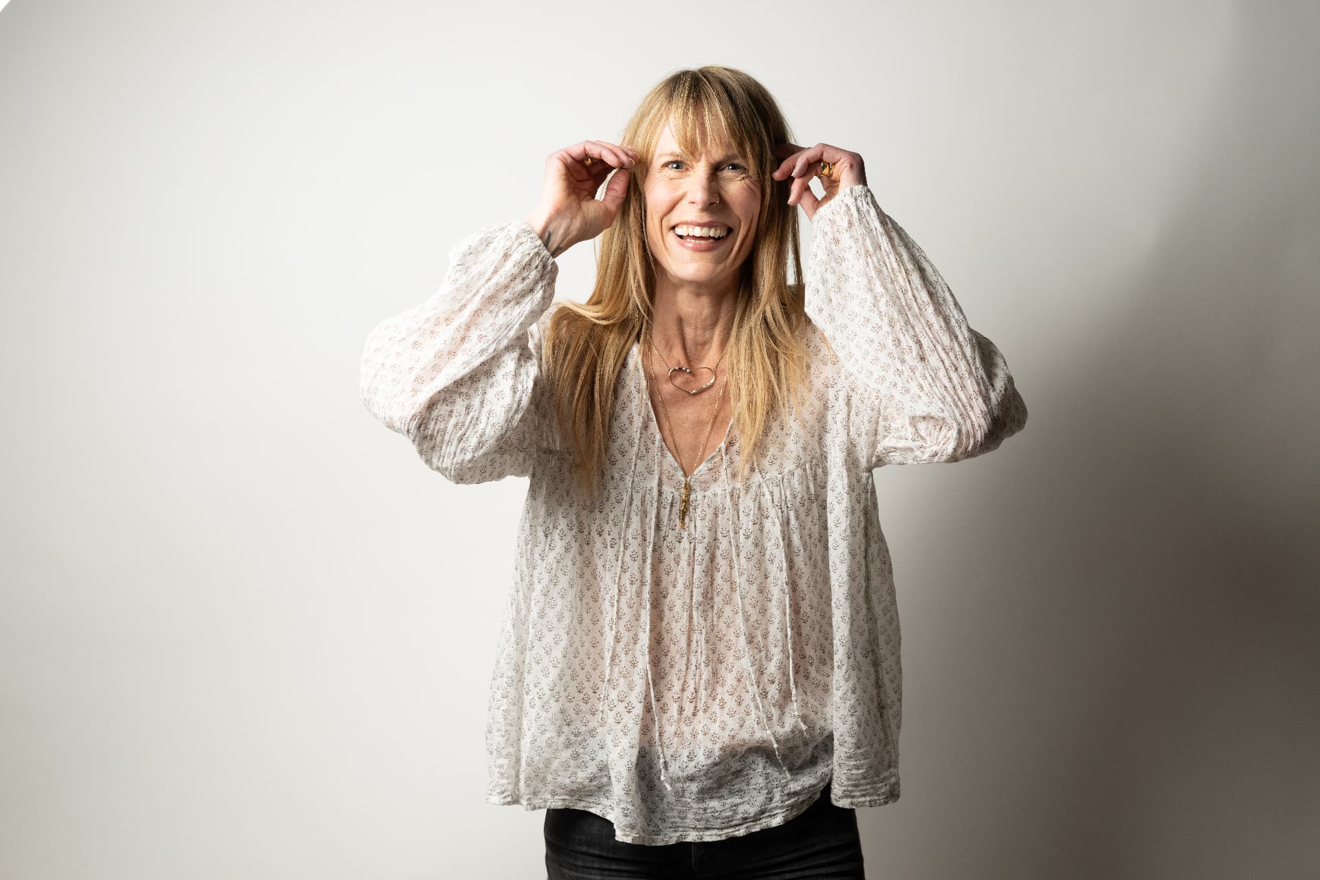 Kristy Scher smiling in a white top