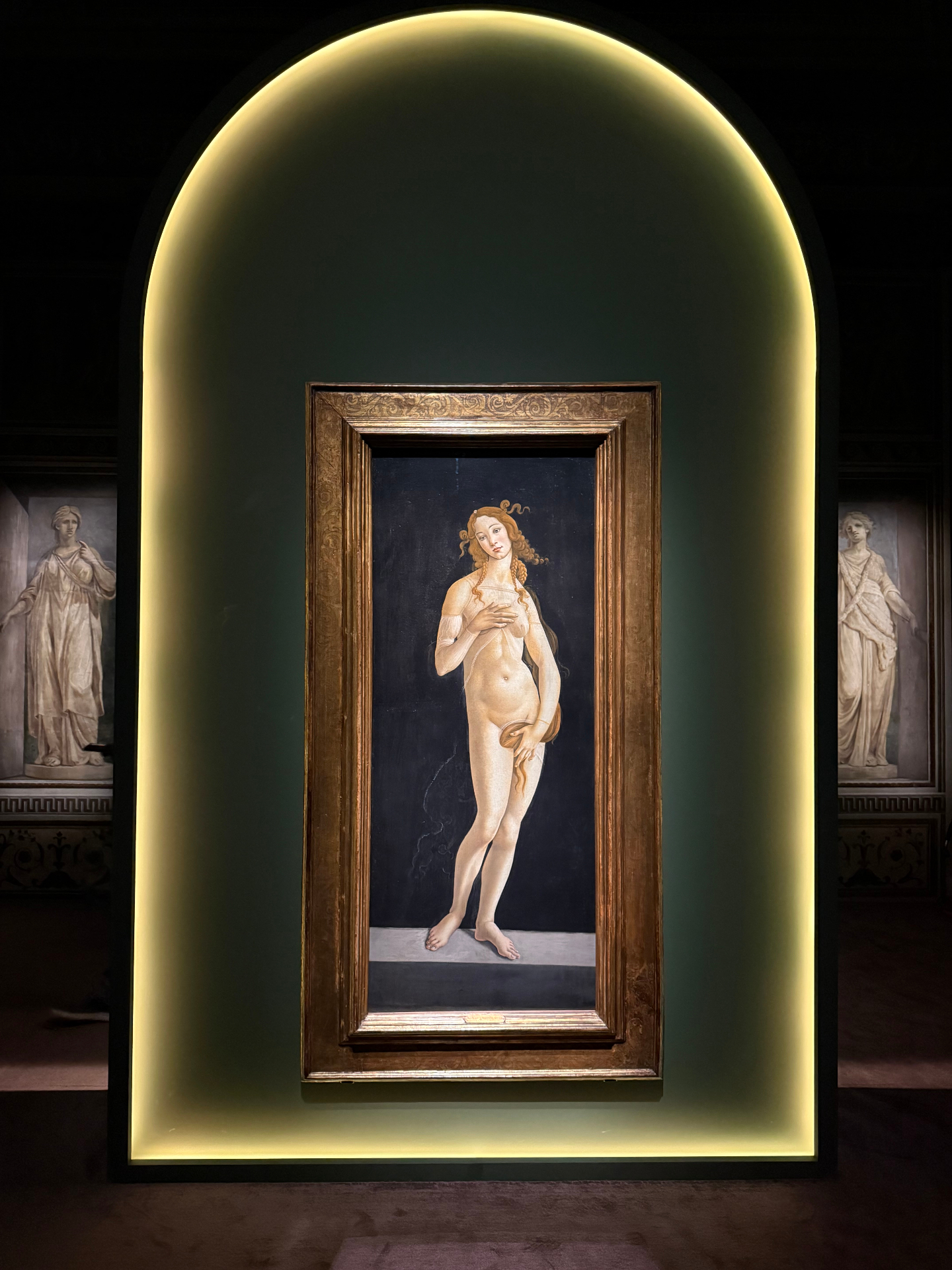Renaissance painting of a serene Venus framed by classical columns